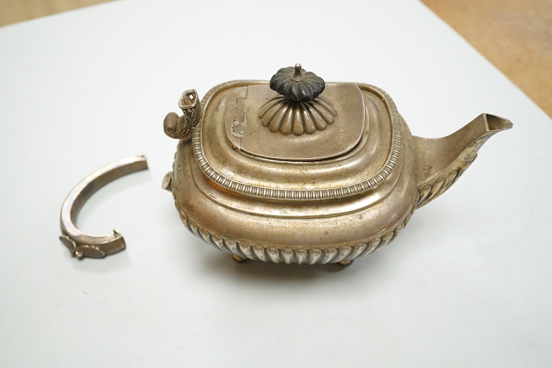 An early 20th century demi-fluted silver oval teapot, by James Dixon & Sons, Sheffield, 1903?, handle detached, together with a George III pierced silver oval salt, by Robert Hennell I, with glass liner(a.f.), gross weig